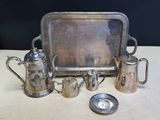 a silver tray with a silver tray and silver cups on it