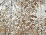 a very large piece of fabric with a bird and flowers on it