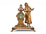 a statue of a woman standing next to a clock