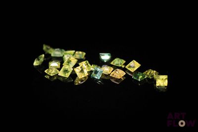 a close up of a bunch of yellow diamonds on a black surface