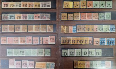 many different types of stamps on display in a glass case