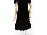 the mannequin is wearing a black dress with ruffles on it