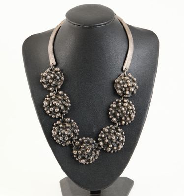 a close up of a necklace on a mannequin on a mannequin