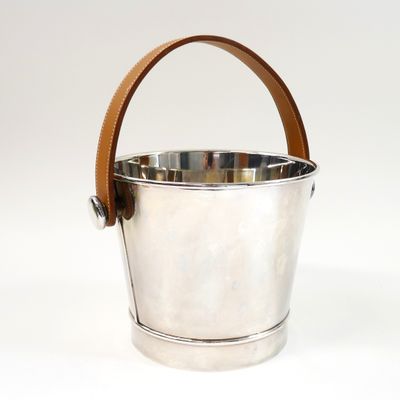 silver ice bucket with leather handle on white background