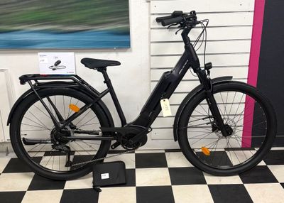 a bicycle that is parked in front of a wall