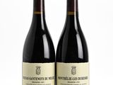 two bottles of wine sitting next to each other on a table
