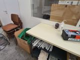 a desk with a lot of papers on it in a room