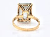 an image of a gold ring with a diamond and a white stone