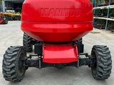 a close up of a red tractor parked in a parking lot