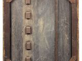 an old wooden door with metal latches and a wooden frame