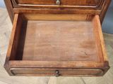 a small wooden box with a drawer on top of it