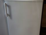 two white appliances sitting next to each other on the floor