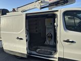 a white utility truck with its door open in the parking lot