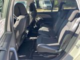 the interior of a car with two rows of seats in the back of it