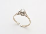 a close up of a diamond ring on a white surface