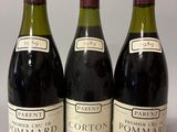 trois bouteilles de vin sont alignées sur une table