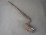 an old rusty tool that is laying on the floor