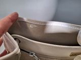 a person that is holding a purse in their hand