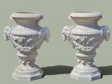 two white vases sitting next to each other on a table