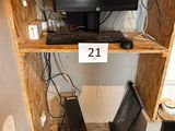 a computer desk with a monitor, keyboard, mouse, and speakers