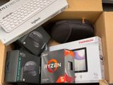 a box with a keyboard, mouse, and other electronics in it