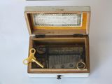 a wooden box with a musical box inside of it