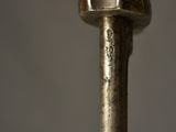 a close up of a metal object with a wooden handle