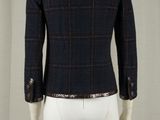 the back view of a mannequin suit with a black and red checkered jacket