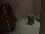 a toilet and a trash can in a small room