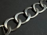a close up of a metal chain on a black surface