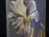 a vase with a flower painted on it on a black background