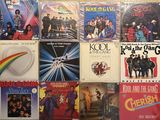 many different album covers on the wall of a room