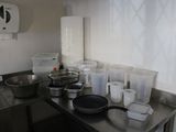 many pots and pans on the counter in the kitchen