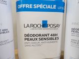 a bottle of lotion sitting on a counter next to other bottles of lotion