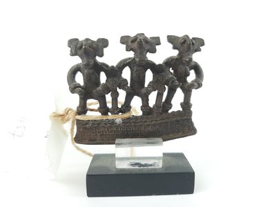 figurine of three elephants in a boat on a wooden base