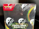 a close up of a box of pokemon trading cards on a table