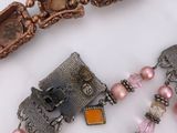 a necklace that has a bunch of beads and charms on it