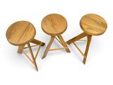 a set of three stools with wooden legs on a white background