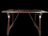 an old wooden table with a marble top on a black background