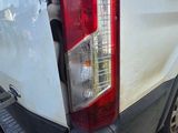 a white truck that has a broken tail light on it