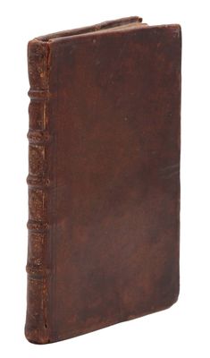 an old book with a brown leather cover on a white background