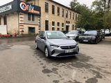 cars parked in a lot in front of a building with a sign on it