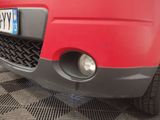 a close up of a red car with a license plate on it