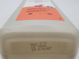 a bottle of liquid sitting on a white surface