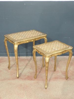 pair of gold side tables with matching stools on carpeted floor