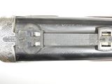 a close up of a gun that is on a white surface