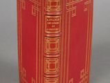 the book is red and gold with gold trimmings on it