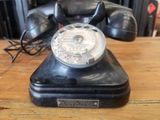 a black telephone sitting on a wooden table