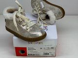 pair of baby shoes with fur lined up on top of a box