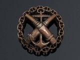 an image of a brooch with a cross and anchor on it